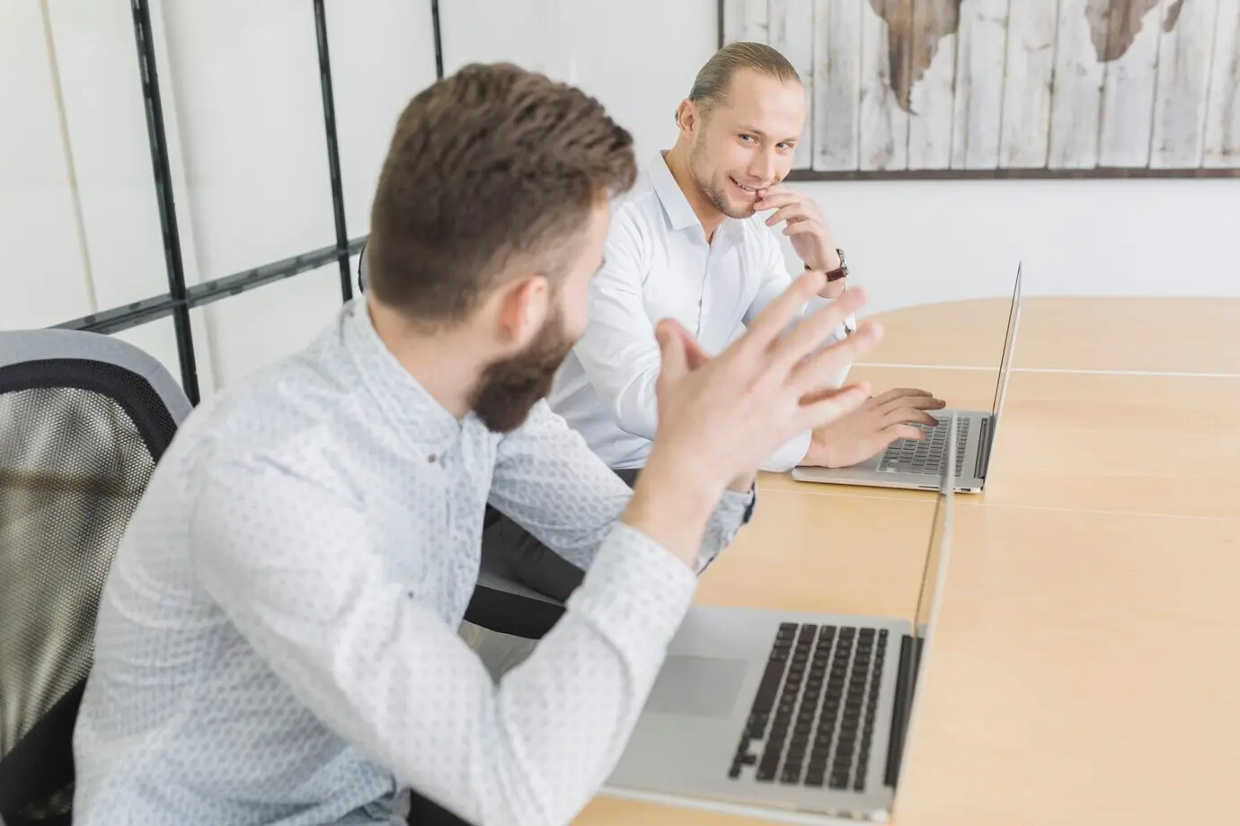 Деловые люди, работающие с ноутбуком в офисе.